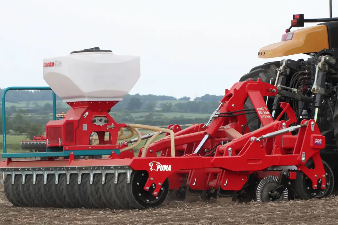 PUMA DC-300 low-disturbance subsoiler with seeder hopper working behind a tractor
